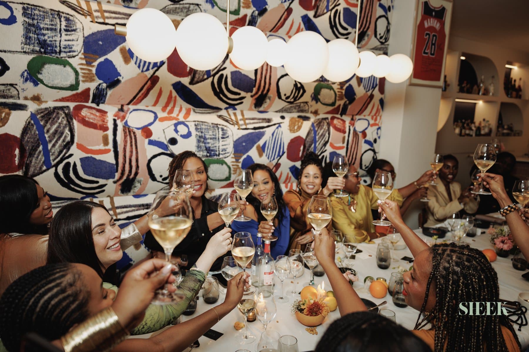 Sheek Circle members raising a toast at a private dinner
